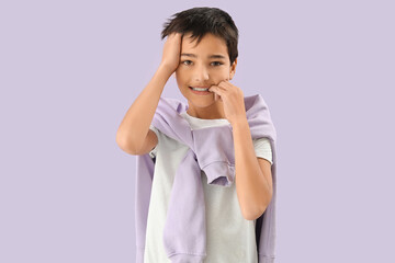 Little boy biting nails on lilac background - obrazy, fototapety, plakaty