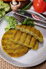 Grilled tasty vegan and vegetarian burgers made from fresh broccoli vegetables and dried legumes and beans