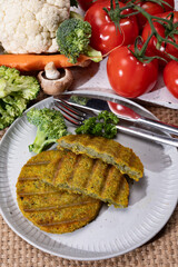Grilled tasty vegan and vegetarian burgers made from fresh broccoli vegetables and dried legumes and beans