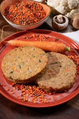 Uncooked fresh vegan and vegetarian burgers made from fresh vegetables and dried legumes and beans