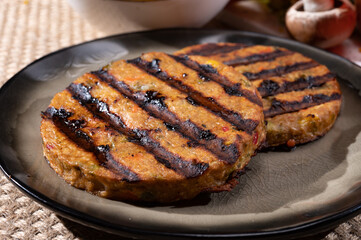Barbecue grilled tasty vegan and vegetarian burgers made from fresh vegetables and dried legumes and beans