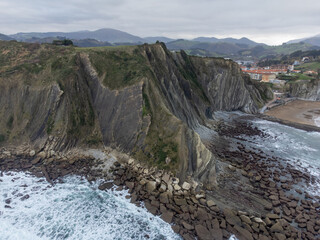 View on steeply-tilted layers of flysch geological formation on Atlantic coast at Zumaia, Basque Country, Spain
