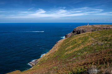 Fototapeta na wymiar Cliffs At Atlantic Coast With Ancient Lighthouse At Cap Frehel In Brittany, France; Phare du Cap Frehel