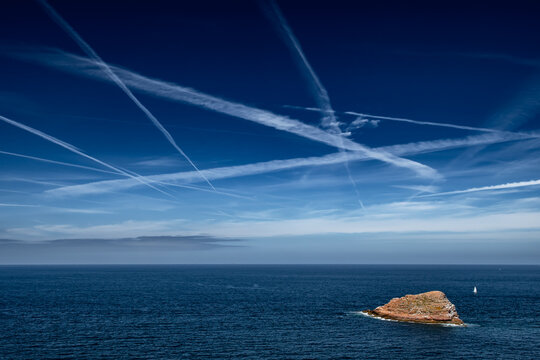 Blue Sky With Grid Of White Condensation Trails, Contrails, From Airplane At The Atlantic Coast In France