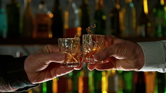 Super Slow Motion Shot of Clinking Glasses in Bar at 1000fps.