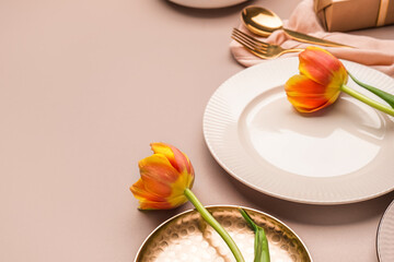 Clean plate and tulip flowers on beige background