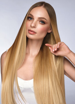 Beautiful blond girl with a perfectly smooth hair, and classic make-up. Beauty face and hair.