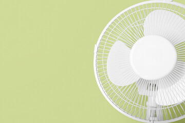 Electric fan on green background