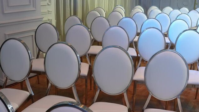 White transparent plastic Chiavari chairs in rows