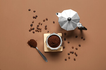 Coffee maker with powder and beans on brown background