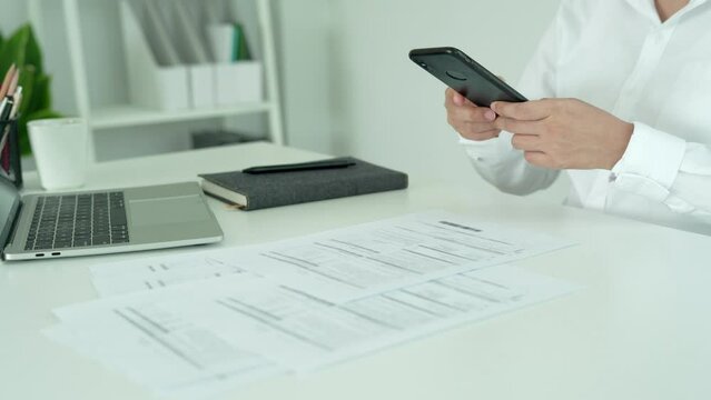 Modern woman use phone to scan barcode or QR codes to pay credit card bill after receive document invoice. payment, receive, paying electricity, digital payments without money, technology, scanning