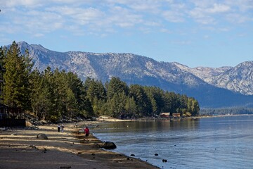 Parasailers and boaters begin their mornings on the peaceful waters of Lake Tahoe in the Sierra...