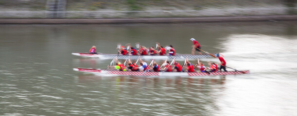 blurred picture of two canoes having a race on a canal