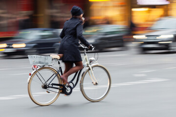 woman riding a bicycle on a city street