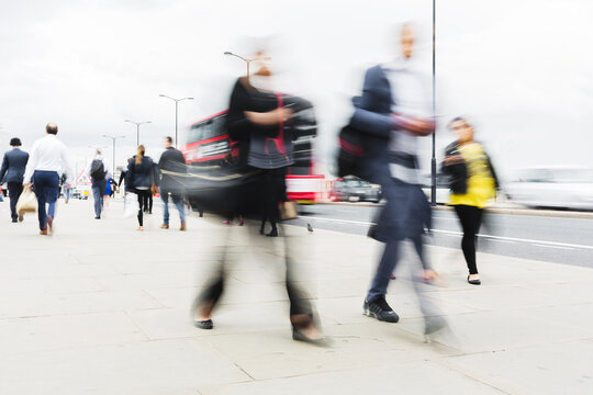 Crowd Of People Walking On A Sidewalk In The City Of London