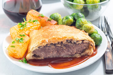 Beef Wellington, served with brussels sprouts and Chateau potato, horizontal