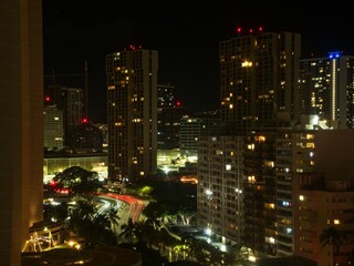 Fototapeta na wymiar Night settles on Honolulu as the lights of the many high-rise hotels of Waikiki begin to illuminate