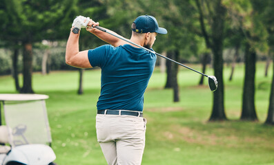 Golf, training and hobby with a sports man swinging a club on a field or course for recreation and fun. Golfing, grass and stroke with a male golfer playing a game on a green during summer