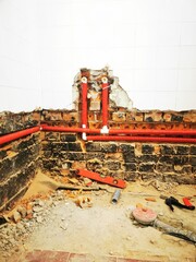 bathroom renovation. installing new water pipe in brick wall, and install new drain pipes in floor