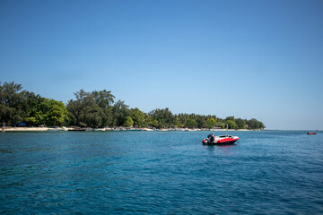 Fototapeta na wymiar Speedboat and tropical shore on summer vacation paradise island, Indonesia