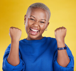 Portrait, happy black woman and fist of winner in studio for celebration, achievement deal and...