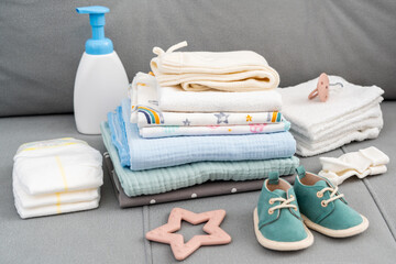 Set of diapers and kids stuff for little baby on a couch. Newborn baby concept