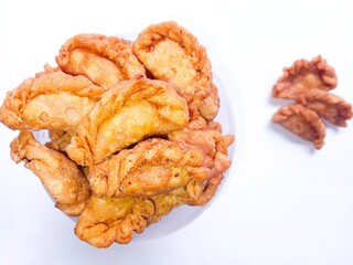 Fried mini pastels isolated on white background. dry snacks. dry patty shell. mini pastels without any filling. crunchy, savory and sweet. brown snack
