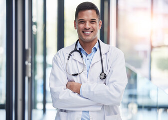 Portrait, man doctor and smile with arms crossed, confidence and professional medicine in hospital....