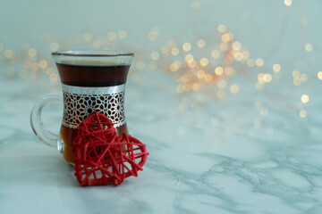 A glass of Tea and a Heart on front with lights in background, Tea day and tea lover Beverage...