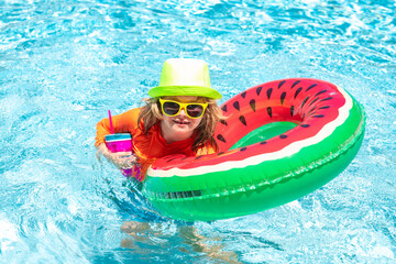 Summer swimming and relax, swim on ring in pool, poolside. Child in swimming pool playing in water. Vacation and traveling with kids. Children play outdoors in summer. Kid with floating ring.