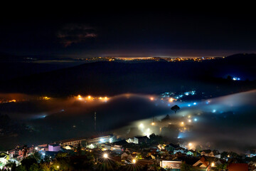 Da Lat City, Lam Dong Province, Vietnam - Da Lat city in fog with brilliant lights in the night. The scene is magical