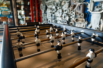 Table football in the entertainment center. Close-up image of plastic players in a football game.
