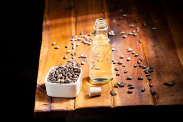 castor seeds and oil, on wooden surface, royalty free
