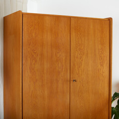 Vintage 1960s oak wood armoire. Mid-Century Modern furniture. Top detail view. 
