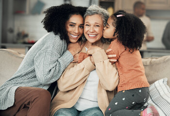 Kiss, portrait and grandmother with girl and woman on a sofa, hug and happy in their home together....