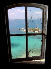 Looking through the window of an old lighthouse at the island of Lengkuas, Bangka Belitung