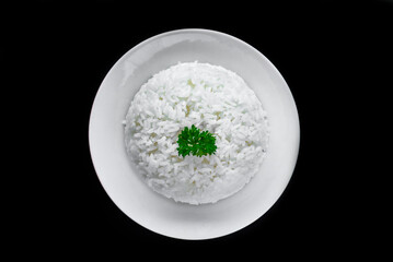 Plate with white rice, serving for Vietnamese dishes on black background