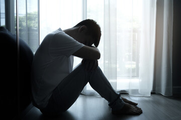 man sitting in the corner of the room have emotional and mental problems He has depression and...