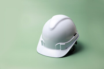 White safety helmet on green background