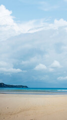 Sandy beach with the blue ocean