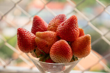 red strawberries in a glass container