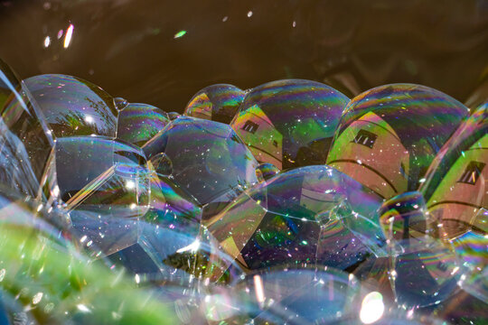 Colorful soap bubbles with mirroring of house