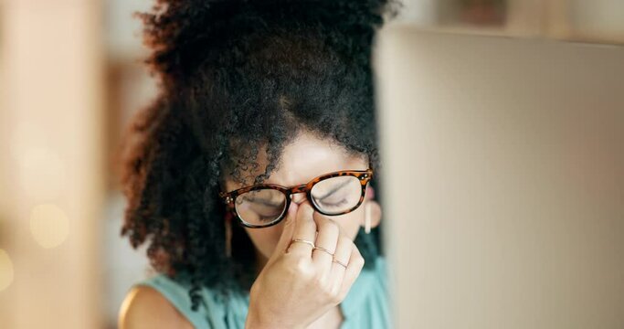 Tired, eye strain and night with black woman at computer for headache, burnout and mental health. Deadline, overtime and pressure with employee and glasses in office for stress, frustrated and pain
