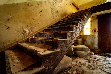 aged staircase with ornaments in an abandoned castle