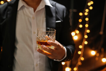 Closeup businessmen holding a glass of whiskey