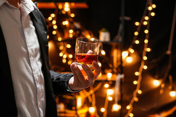 Closeup businessmen holding a glass of whiskey