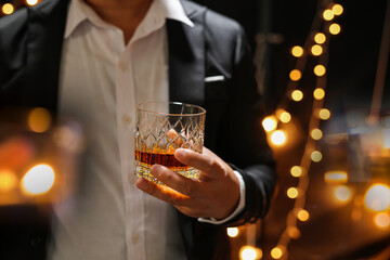 Closeup businessmen holding a glass of whiskey