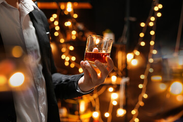 Closeup businessmen holding a glass of whiskey
