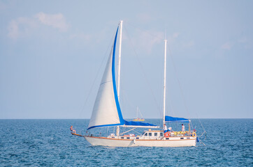 Fototapeta na wymiar Sailing yacht in the blue calm sea.