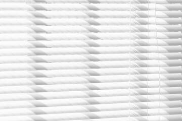 Obraz premium White window shades under the sunlight.